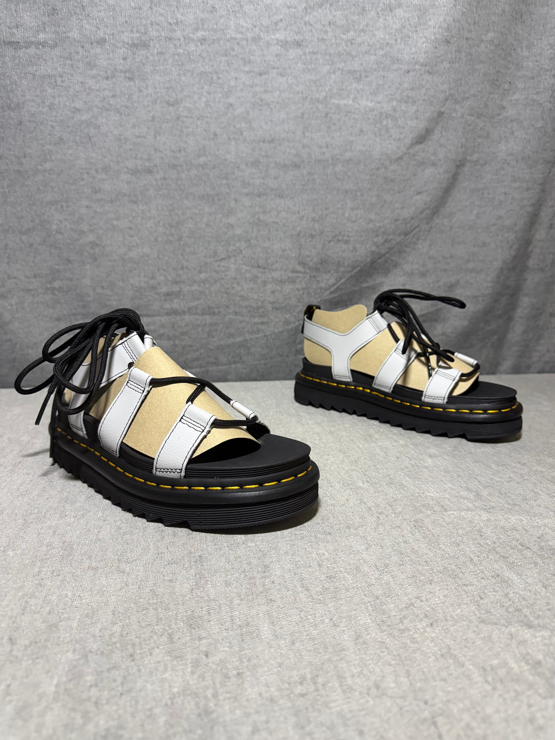 Dr. Martens Nartilla gladiator sandals in mist grey leather with black wraparound laces and a chunky platform sole.