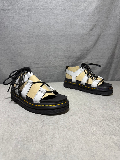 Dr. Martens Nartilla gladiator sandals in mist grey leather with black wraparound laces and a chunky platform sole.