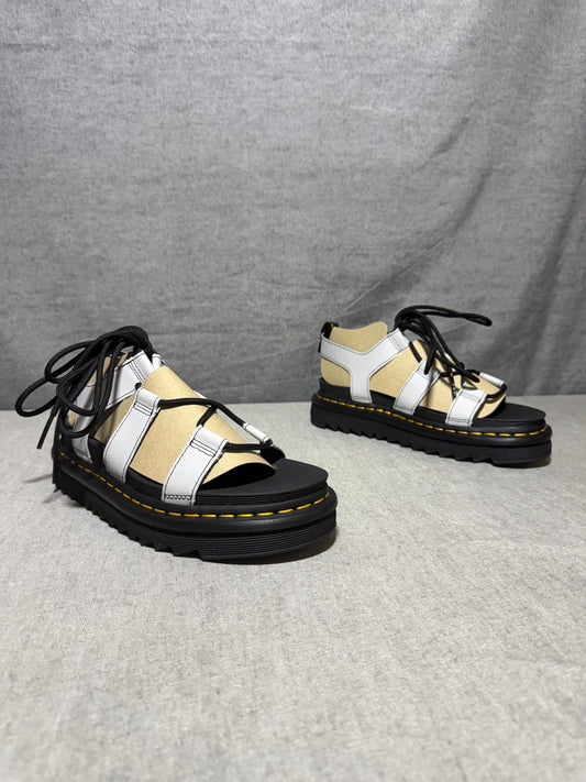Dr. Martens Nartilla gladiator sandals in mist grey leather with black wraparound laces and a chunky platform sole.
