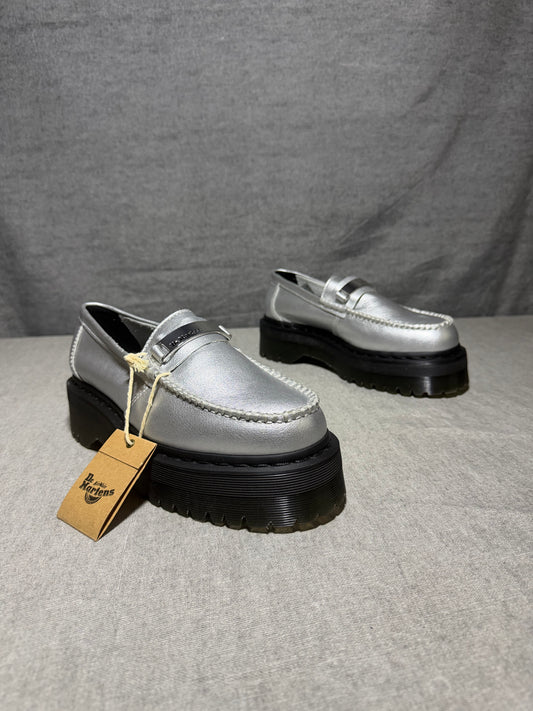 Dr. Martens Penton II Quad slip-on loafers in silver metallic pebbled leather with a chunky platform sole and metal logo plate.